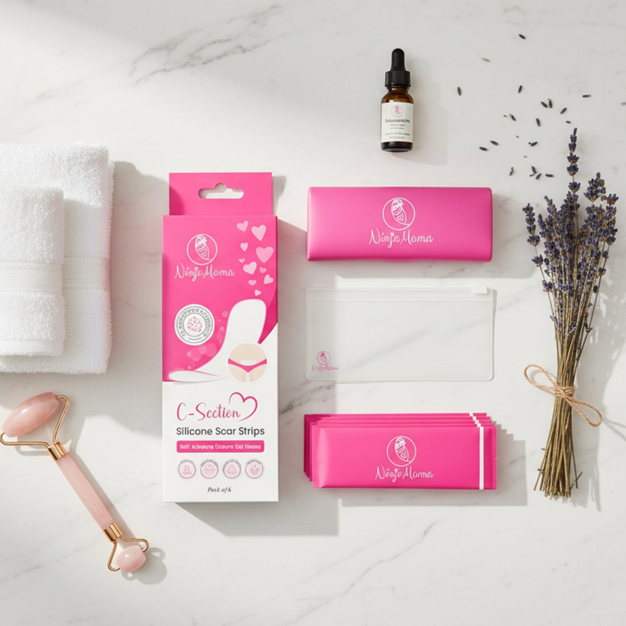 Collection of Ninja Mama silicone c section scar strips including silicone scar strips with keep clean case and zip lock pouch , a bottle, and a roller on a marble 