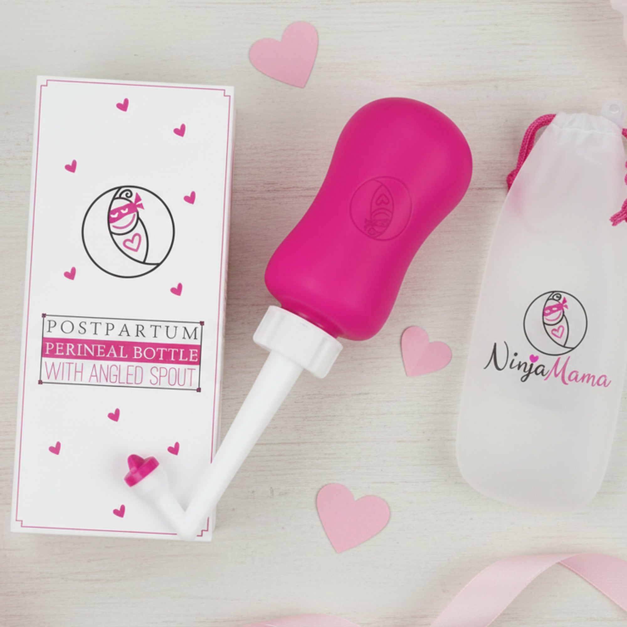 peri bottle laid out with a box for a gift with ribbon