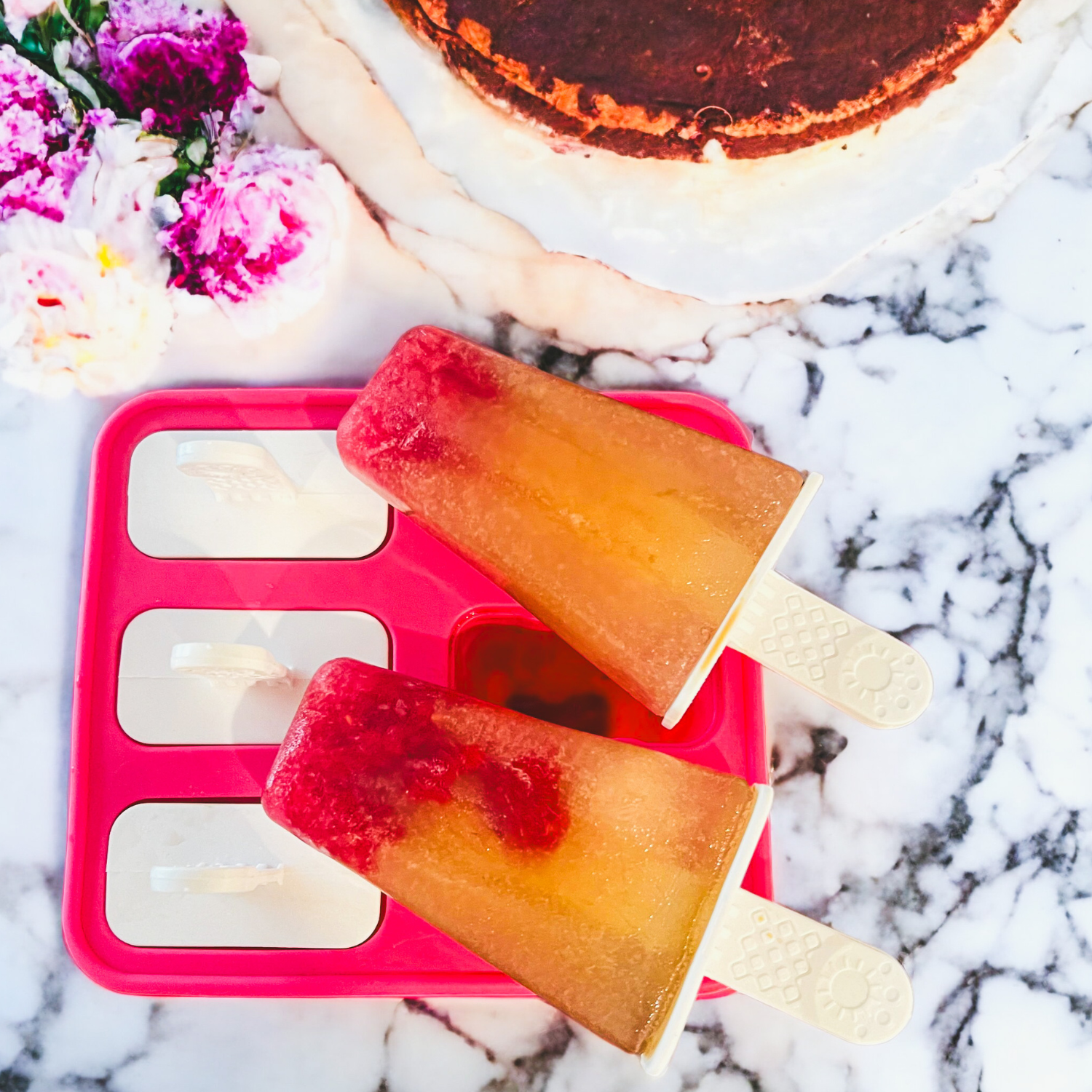 prepare to push organic raspberry tea as popsicles on a pink mould on a marble counter